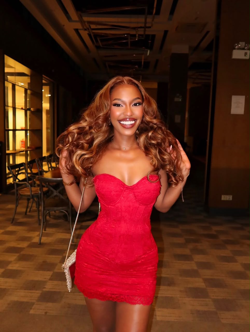 Nessahair customer wearing warm, flowing waves with a red evening dress
